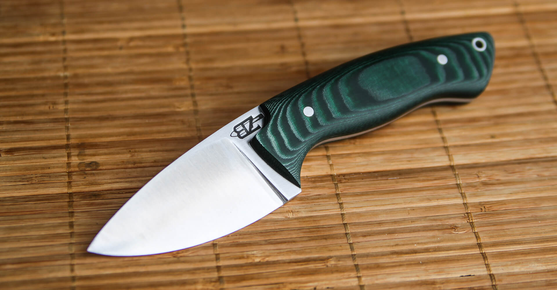 drop point with green micarta